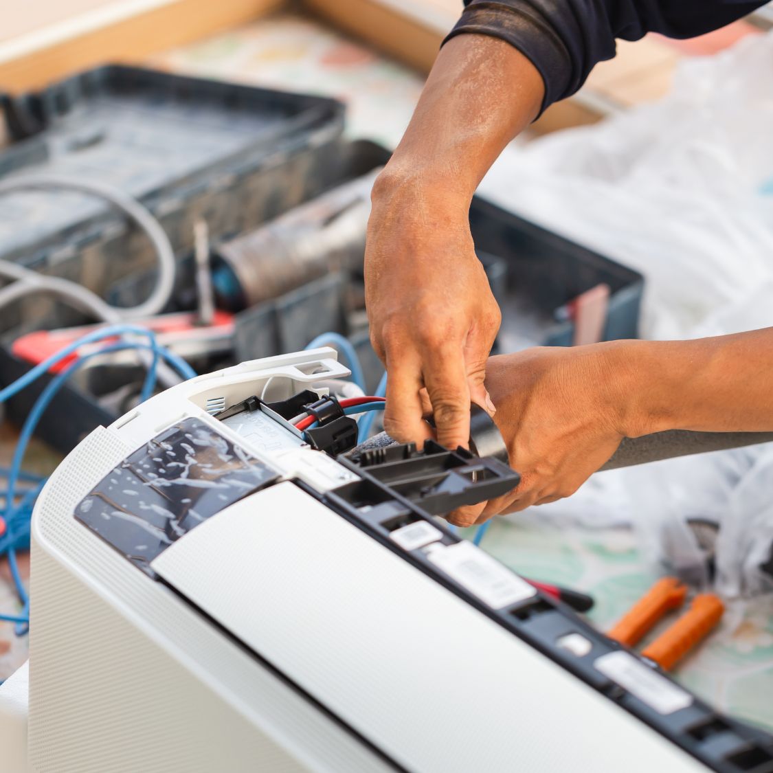 Air conditioning technician installing new air conditioner in a home