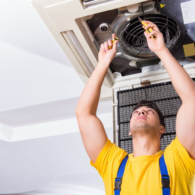 Technician working on Air Conditioner System